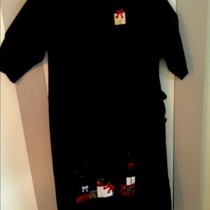 Cotton/poly knit dress with 3/4 sleeves. Christmas appliqués along hemline.